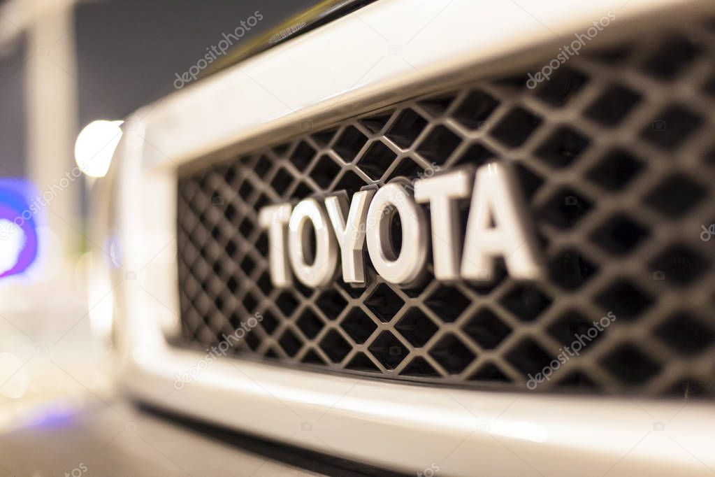 ABU DHABI, UAE - NOV 26, 2016: Toyota company logo on a car illuminated at night