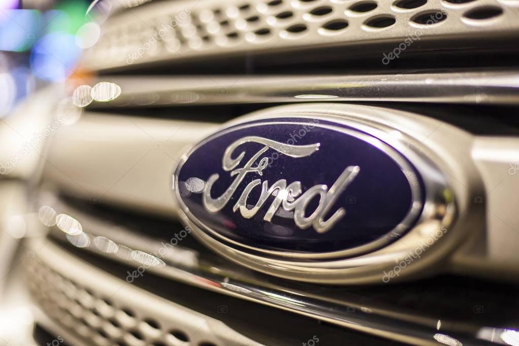 ABU DHABI, UAE - NOV 26, 2016: Ford company logo on a car illuminated at night