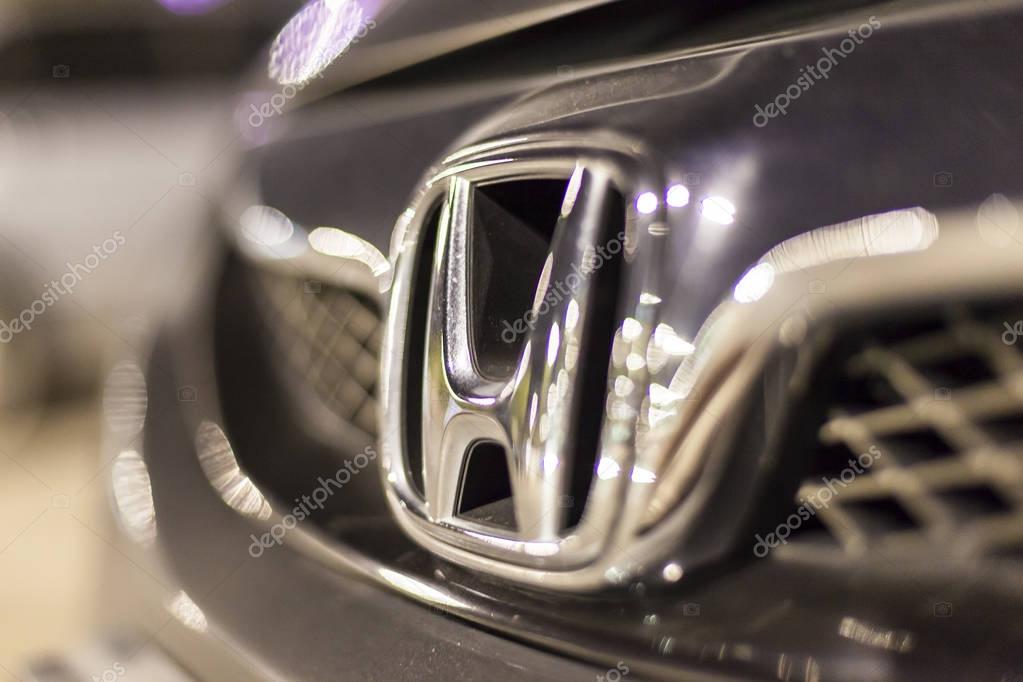 ABU DHABI, UAE - NOV 26, 2016: Honda company logo on a car illuminated at night