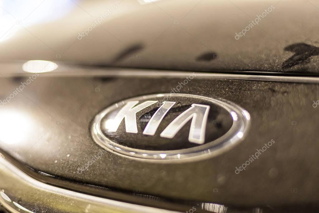 ABU DHABI, UAE - NOV 26, 2016: KIA company logo on a car illuminated at night
