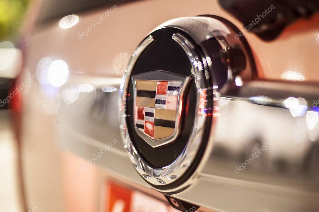 ABU DHABI, UAE - NOV 26, 2016: Cadillac company logo on a car illuminated at night