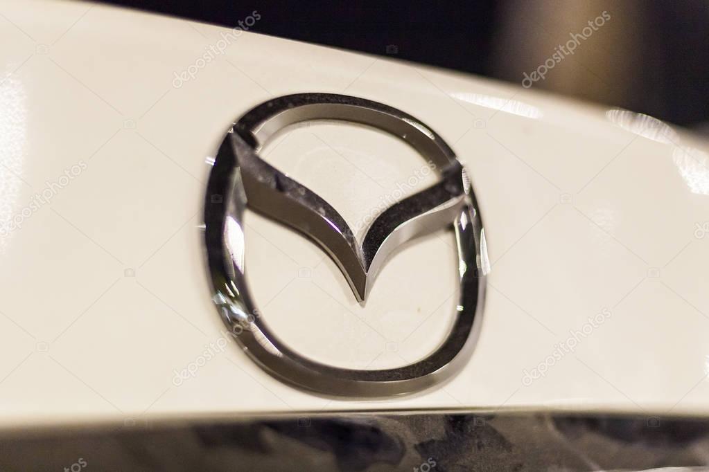 ABU DHABI, UAE - NOV 26, 2016: Mazda company logo on a car illuminated at night
