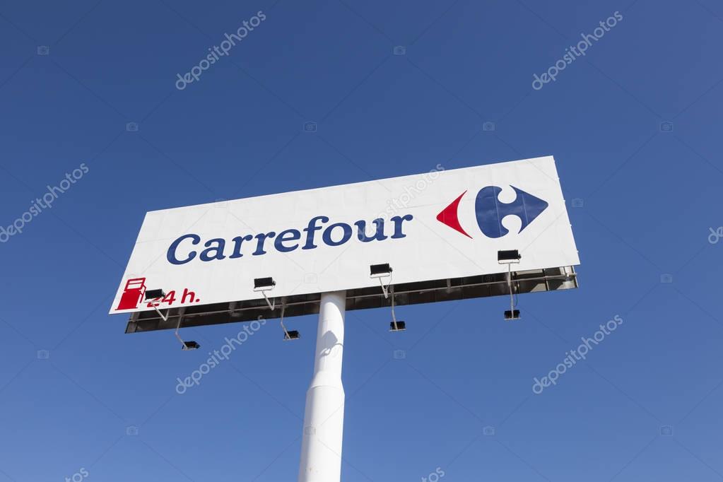 Huelva, Spain - June 3, 2017: Logo of the french supermarket chain Carrefour in the city of Huelva, Andalusia, Spain