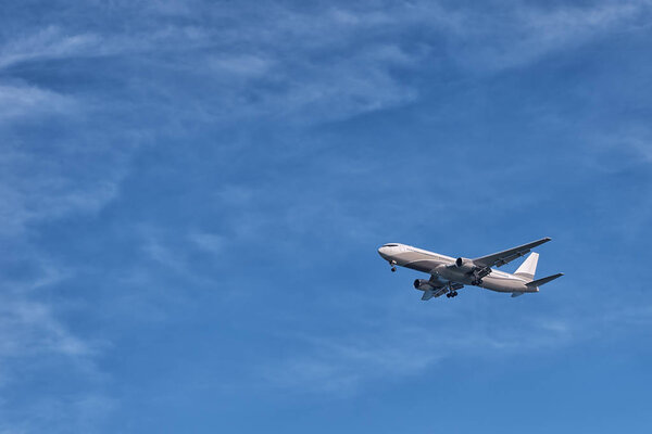 The plane flying in the sky a close up the bottom view