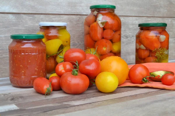 Preserved and fermented food in glass jars. Fermented food. Autumn canning. Tomatoes pickling and canning into glass jars. Canned pickled tomatoes in glass jars, Russain country cuisine
