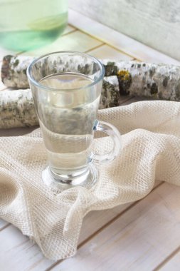 Glass with fresh birch sap. Vertical image
