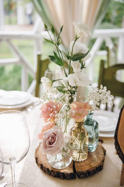 Flowers and greenery composition as a decoration of wedding table