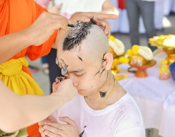 Asian man who will be monk shaving hair for be Ordained to new m