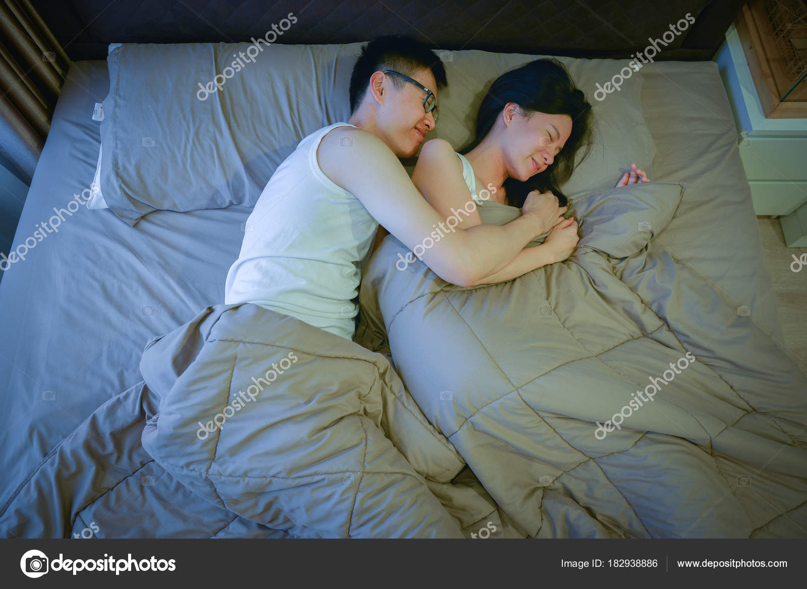 Asian Couple In Love Sleeping Together On Bed At Night