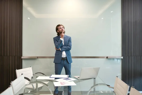 Hombre de negocios rubio presentando un proyecto en tablero de vidrio en blanco — Foto de Stock