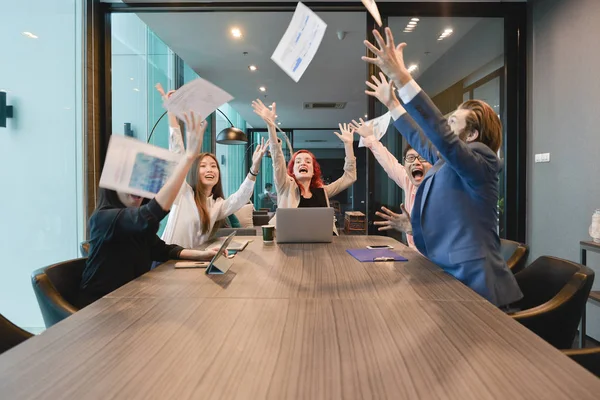 Teamwork of business people excited, business documents fly in a