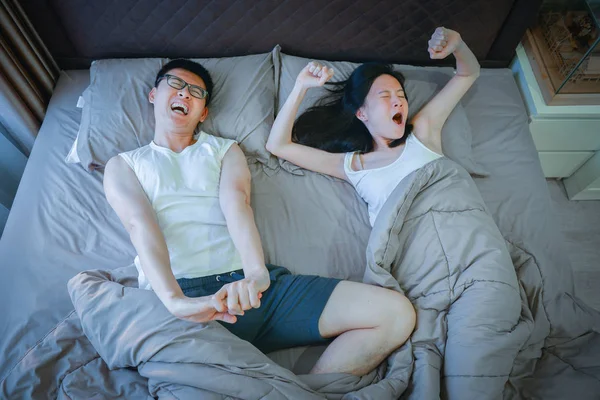 Asian couple stretching on bed in bedroom — Stock Photo, Image