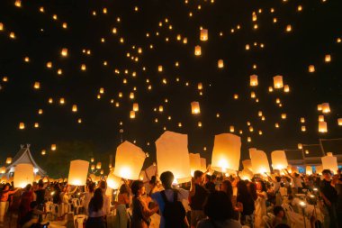 Thai people release sky floating lanterns or lamp to worship Bud clipart