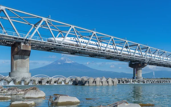 Shinkansen train. Fast bullet train, driving and passing Mountai