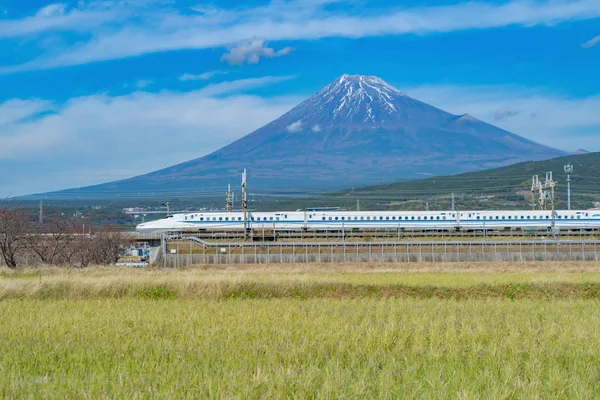 Shinkansen train. Fast bullet train, driving and passing Mountai