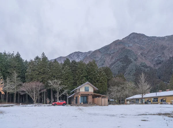 A house with dry trees and snow in Fumotoppara Camping Grounds in winter season near Fujikawaguchiko, Yamanashi. Five lakes, Japan. Nature landscape background