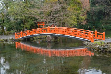 The red bridge at Fujisan Hongu Sengen Taisha temple, Fujinomiya, Shizuoka city, Japan. Tourist attraction. Architecture landscape background. clipart