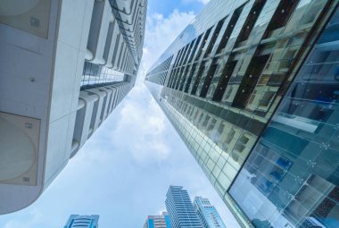 Yüksek binalara, gökdelenlere, mavi gökyüzü olan finans bölgesindeki mimarilere bakıyorum. Şehir merkezi Dubai, BAE 'de iş ve teknoloji konsepti için akıllı şehir..