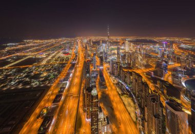 Dubai şehir merkezinin gökyüzü manzarası, Birleşik Arap Emirlikleri veya BAE 'deki karayolları veya caddeler. Finansal bölge ve şehir merkezindeki iş alanı. Geceleri gökdelen ve yüksek binalar.