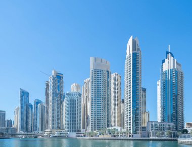 Ofis binalarının pencereleri. Şehir merkezi Dubai 'de cam mimari ön cephe tasarımı. Mavi gökyüzü ile finans bölgesinde şehir.