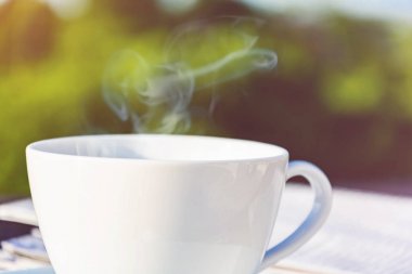 Kahve Kupası saat ve haber kağıt üzerinde eski ahşap masa