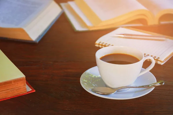 Coffee mug and book on old wooden table — Stock Photo, Image