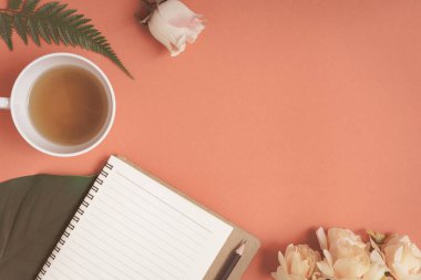 Düz yatıyordu defter ve gül kırmızı bir masa üzerine yerleştirilen