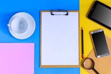 İş ekipmanları renkli kağıt arka plan üzerine yerleştirilen