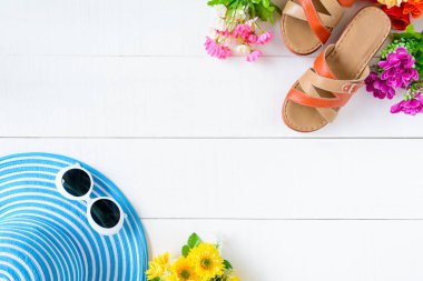 Mavi şapka güneş gözlüğü ve ayakkabı Beyaz ahşap masa üzerinde