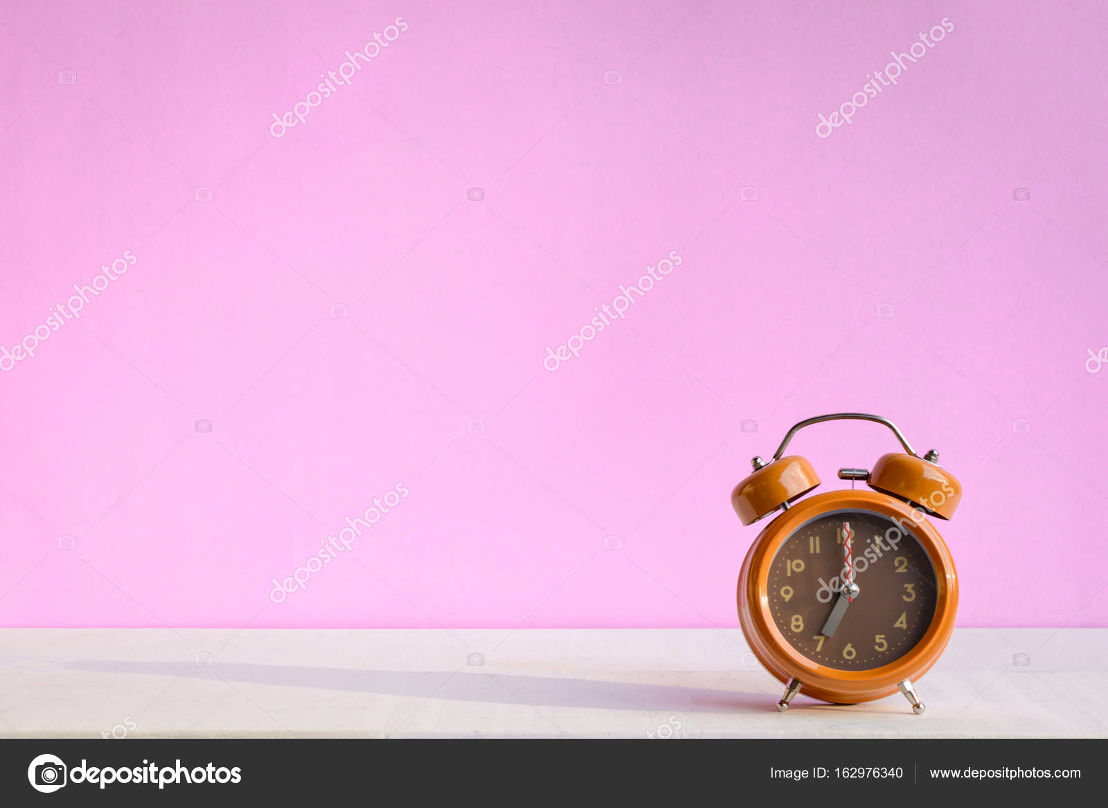 White Desk Clock With Pink Sweet Wall Stock Photo White Desk Clock With Pink Sweet Wall Stock Photo