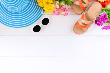 Mavi şapka güneş gözlüğü ve ayakkabı Beyaz ahşap masa üzerinde