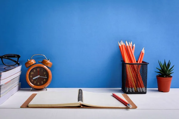 Books Pencil and glasses on a white wooden table are clocks and Stock Photo