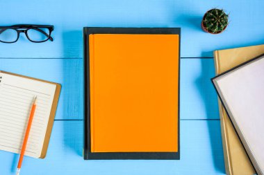 Üstten Görünüm kitap mockup ve kalem kayda göre mavi ahşap masa