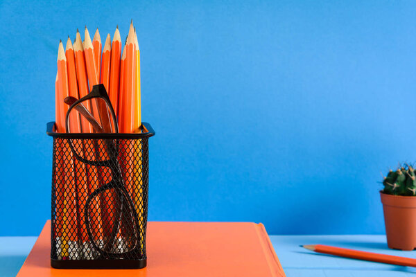 Books Pencil and glasses on a blue wooden table