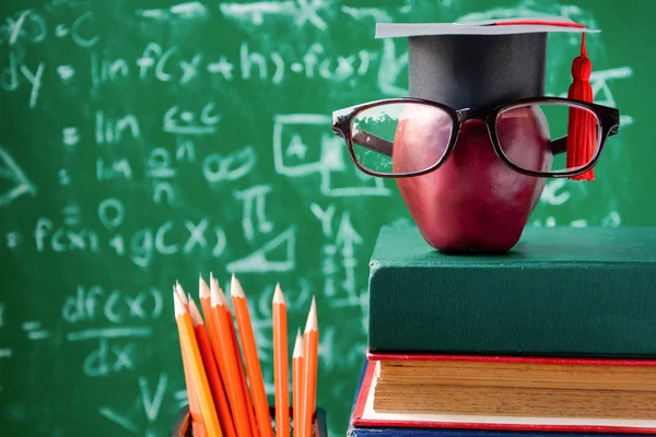 Apple Knowledge Symbol and Pencil Books on the desk — Stock Photo, Image