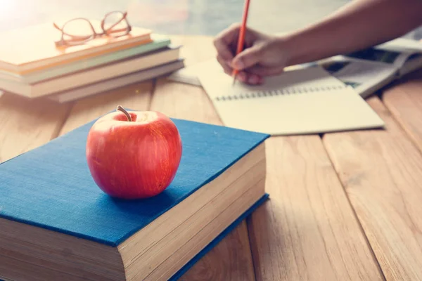 Books Pencil and apple on a white wooden table — Stock Photo, Image