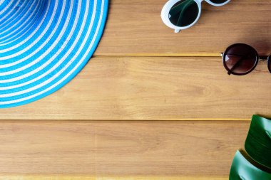 Üstten Görünüm mavi şapka ve güneş gözlüğü ahşap bir masa üzerinde 