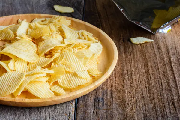 Snacks in a wooden dish on a table — Stock Photo, Image