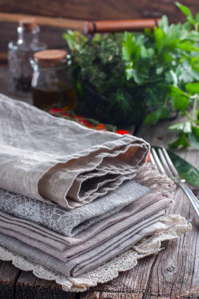 Clean linen towels on the kitchen table, selective focus