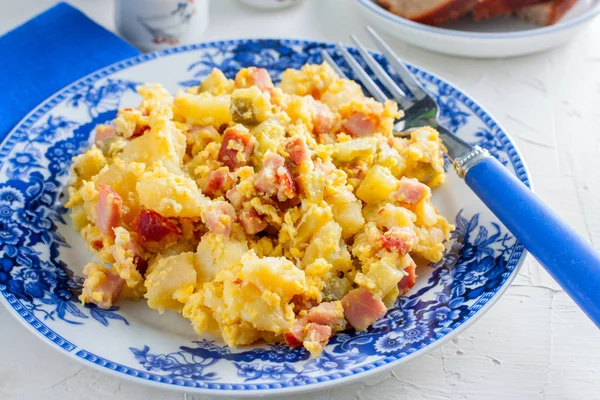 Traditional breakfast with potatoes, ham and eggs, horizontal