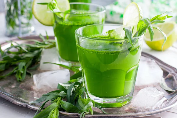 Two glass glasses with a drink from the leaves of the tarragon, horizontal