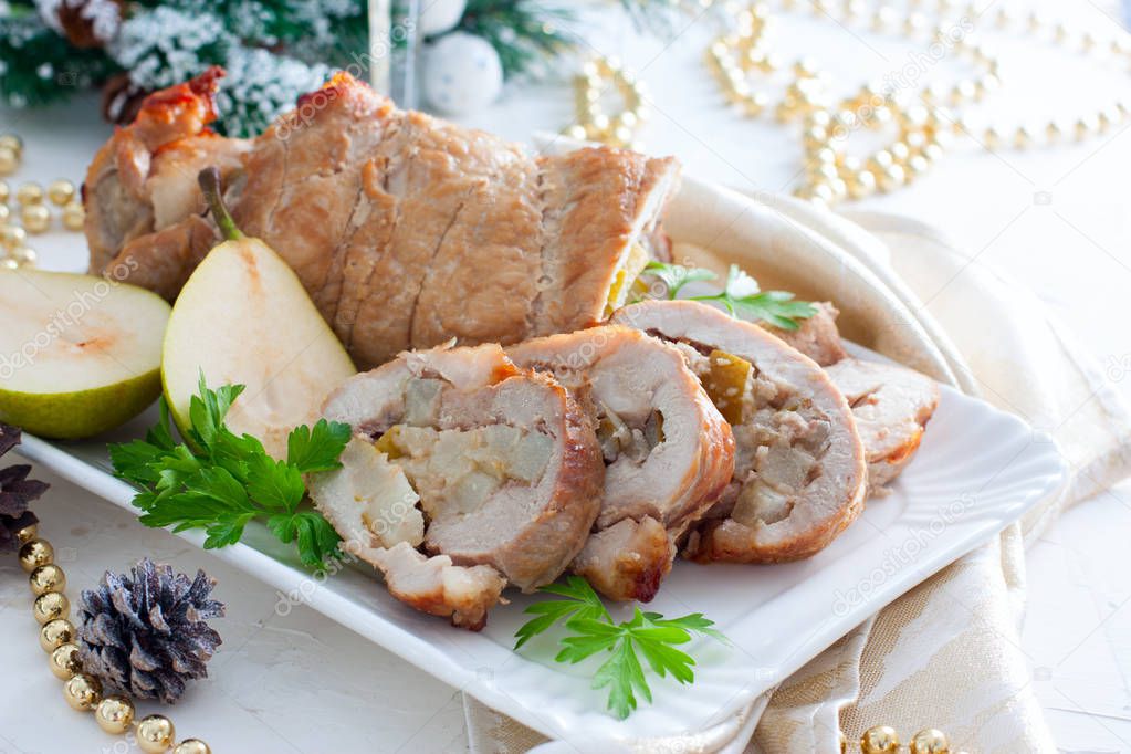 Meatloaf with pear on festive table, horizontal