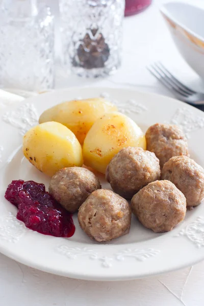 Meatballs with cream sauce and cranberry jam, on a white plate, selective focus — Stock Photo, Image