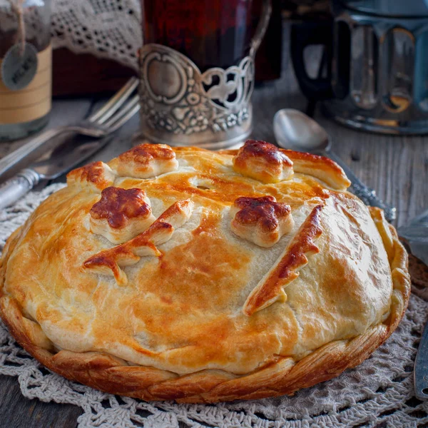 Traditional festive Russian pie - Kournik (pie with chicken and pancakes), square