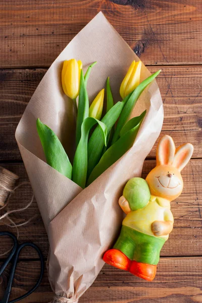 Праздничные тюльпаны и элегантный пасхальный кролик на деревянном фоне, вид сверху. Пасхальная концепция . — стоковое фото