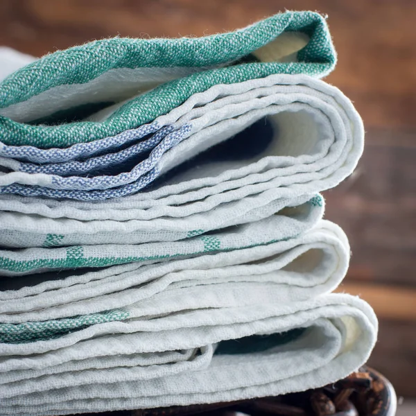 Чистые кухонные полотенца сложены в корзину на корзине, избирательный фокус — стоковое фото