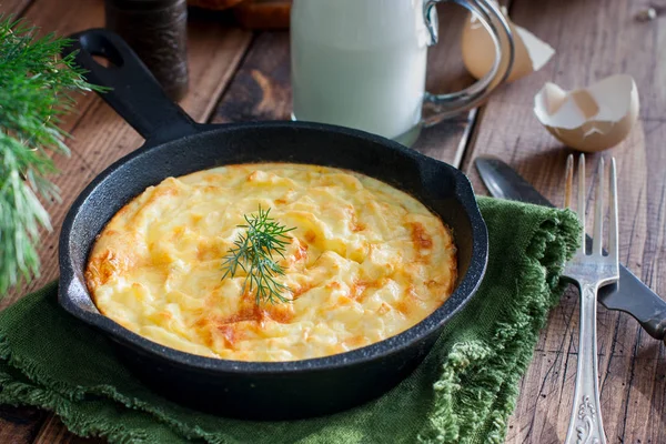 Aardappel braadpan in een gietijzeren koekenpan op een houten tafel, horizontale — Stockfoto