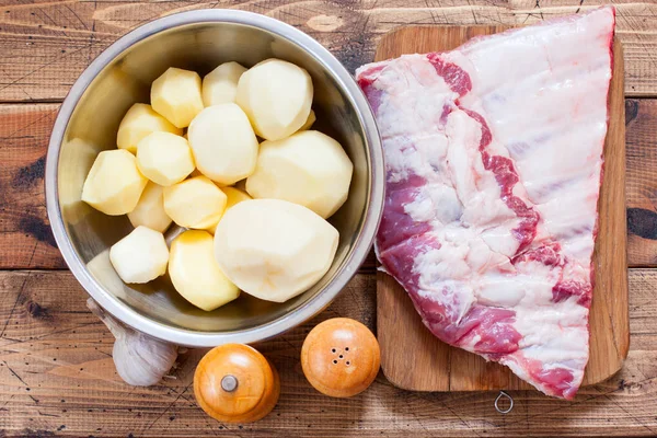 Step-by-step preparation of pork ribs with potatoes in the oven, step 1- preparation of ingredients, top view, selective focus