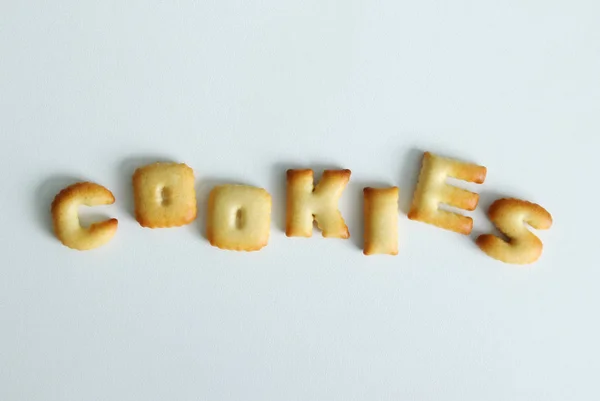 Uma inscrição dos biscoitos no fundo branco . — Fotografia de Stock