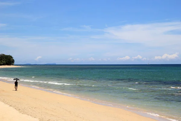 Pohled na písčité pláži s modrým mořem za slunečného dne. — Stock fotografie